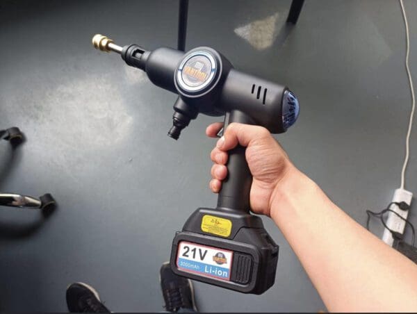 A person holding a VANTOOL Upholstery Portable Sprayer Plus (2 batteries & 2 chargers).