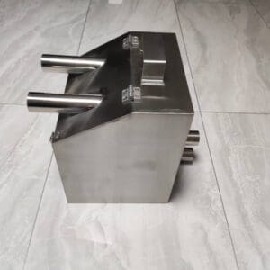 A metal object sitting on top of a tile floor.