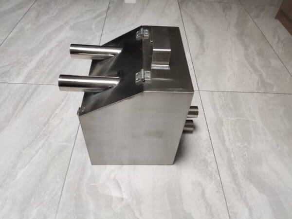 A metal object sitting on top of a tile floor.