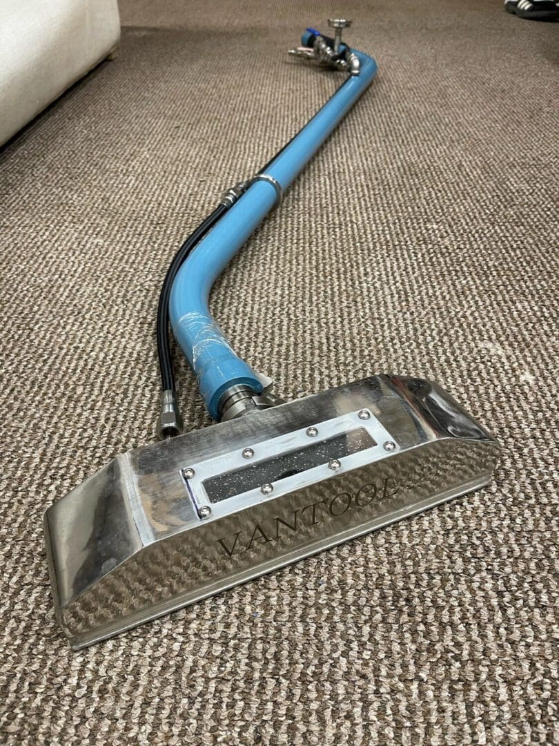 A carpet cleaning machine is laying on the floor.