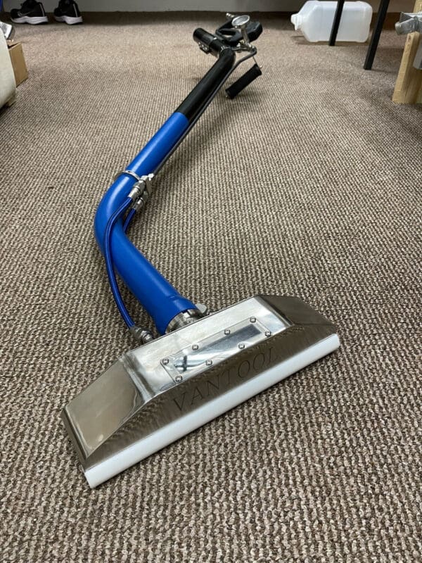 Blue and silver carpet cleaning tool.