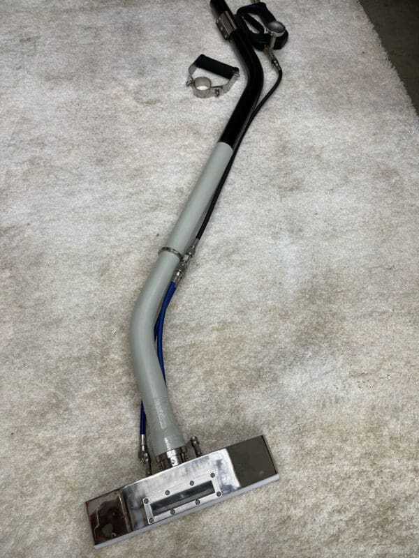 Carpet cleaning wand with hoses.