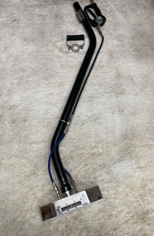 Carpet cleaning wand with handle and hose.