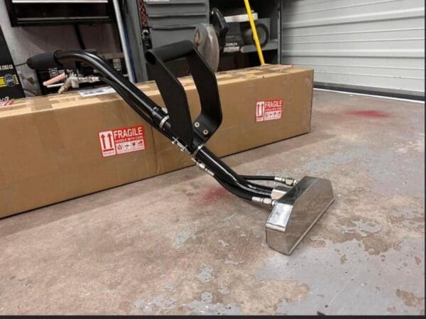 Black and silver floor cleaning tool.