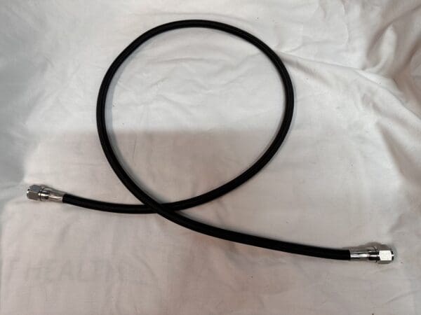 Black braided hose with metal connectors.