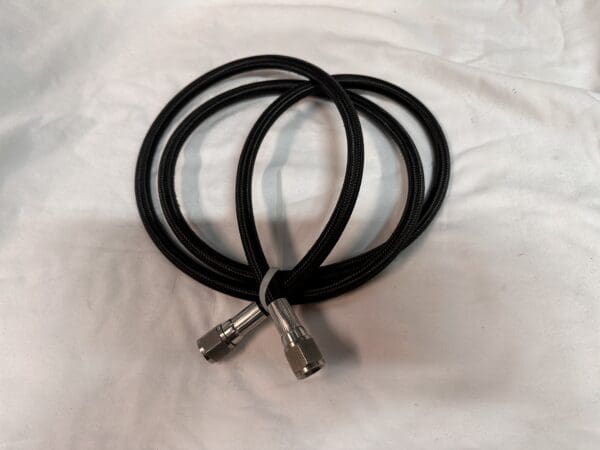 Black braided hose with two connectors.