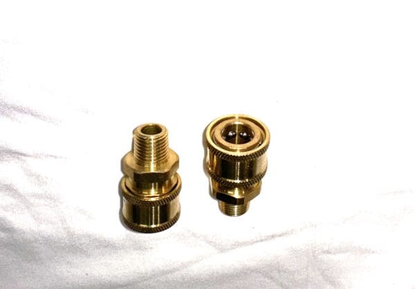 Two gold-colored pressure washer connectors.