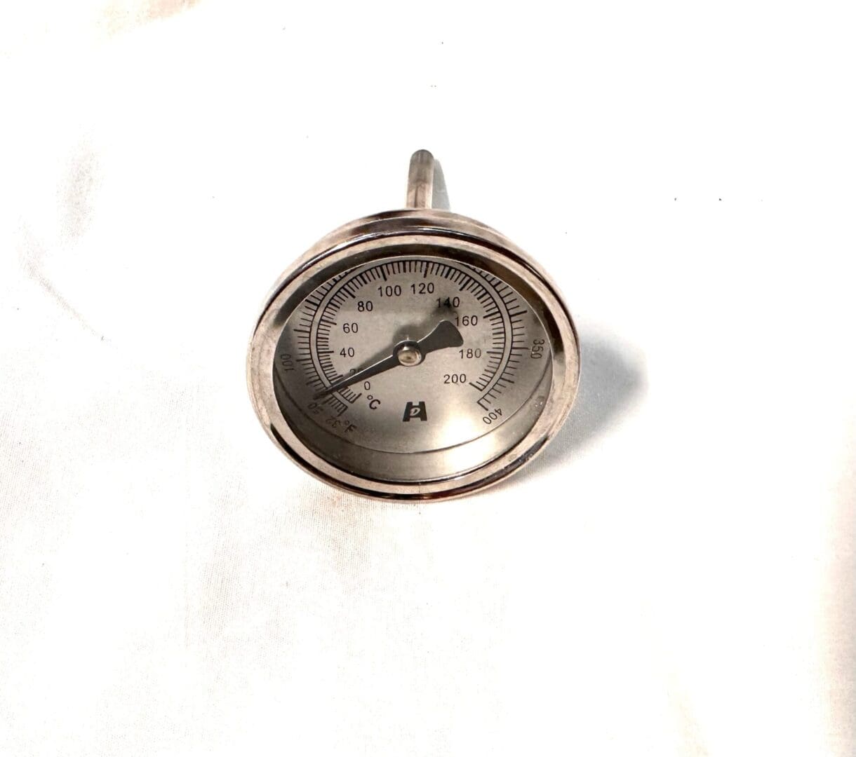 Silver analog thermometer with gauge.