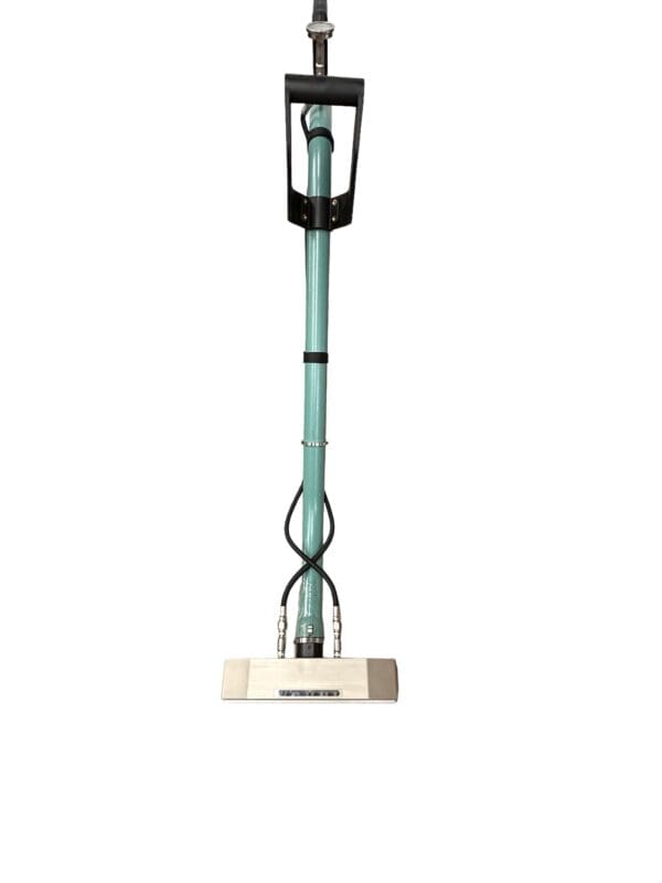 Green and black floor cleaning tool.