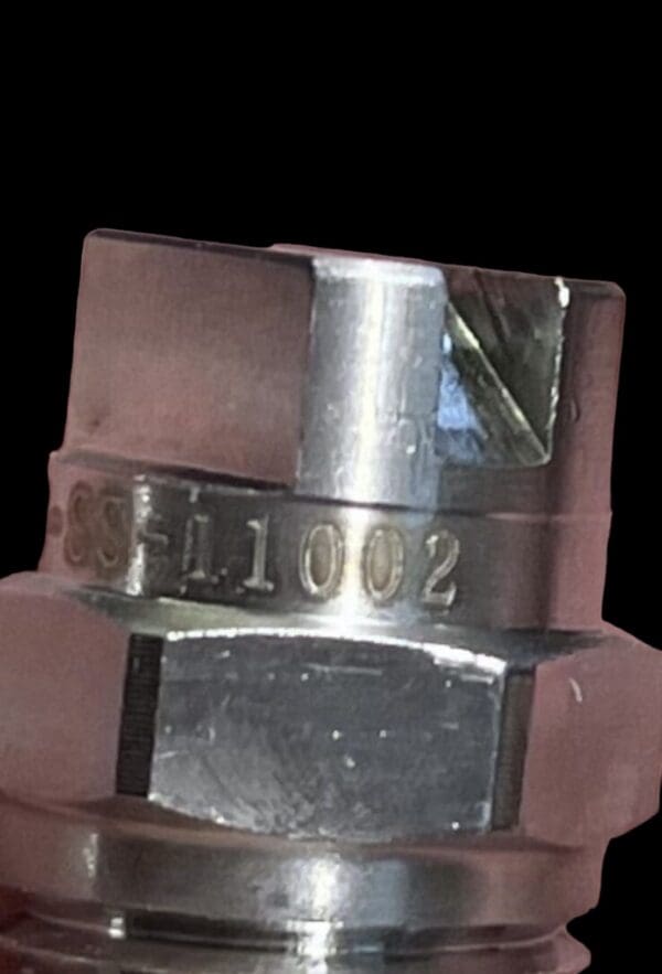 Metal spray nozzle with number 1002.