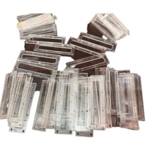 Clear plastic rectangular pieces stacked.