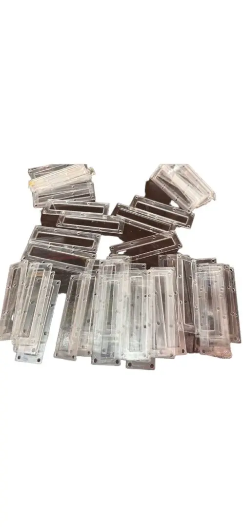 Clear plastic rectangular pieces stacked.