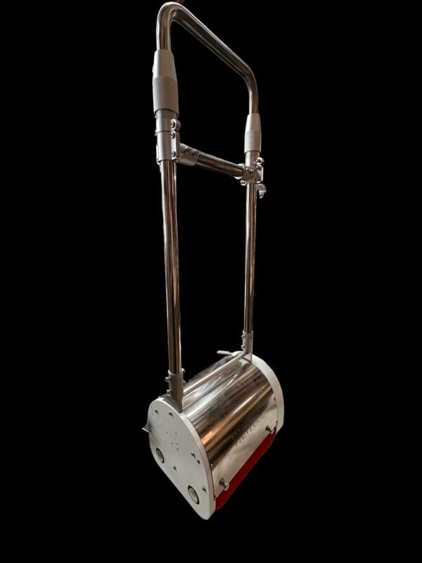 Silver floor polisher with red brush.