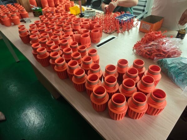 Orange plastic parts on a table.