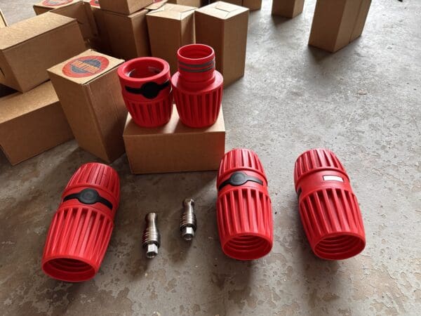 Red and black hose couplings on floor.