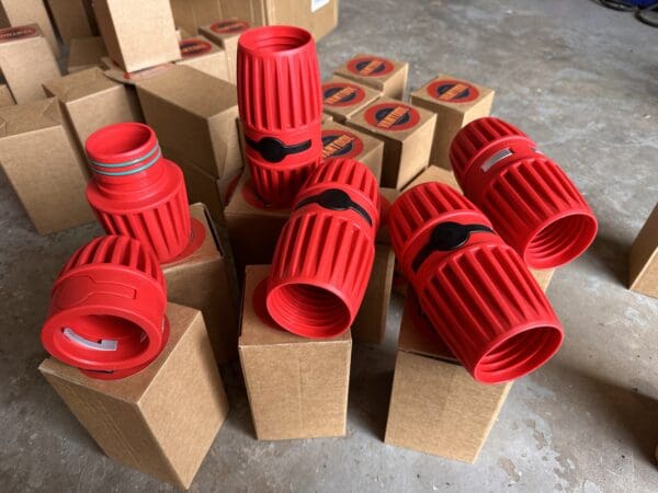 Red plastic hose connectors on boxes.