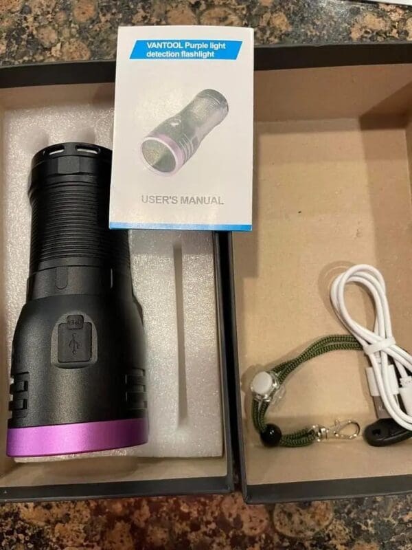 Purple light detection flashlight in box.