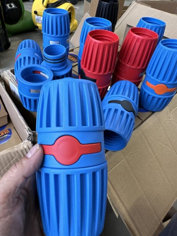 Blue and red plastic connectors in a box.