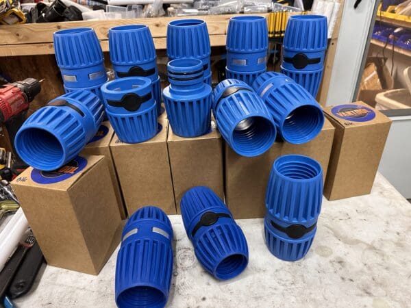 Blue plastic pipe connectors in boxes.