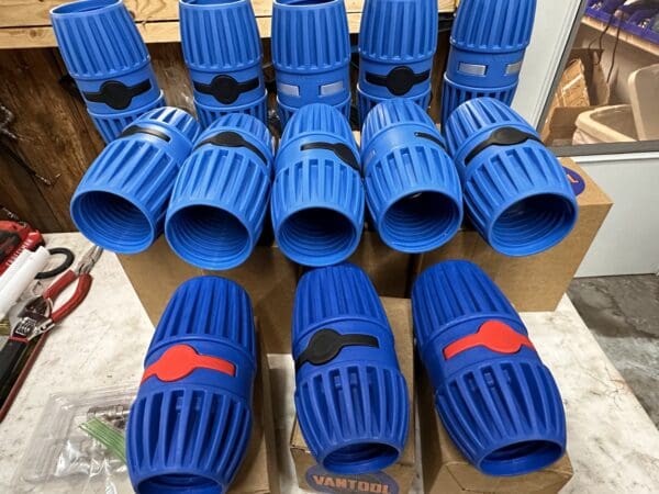 Blue plastic pipe connectors on a table.