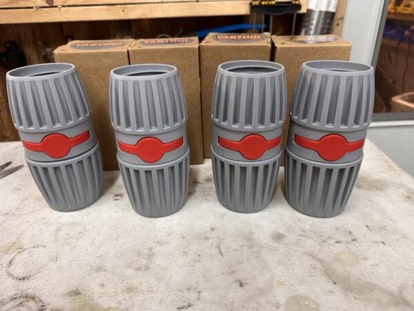 Four gray and red cylindrical objects.