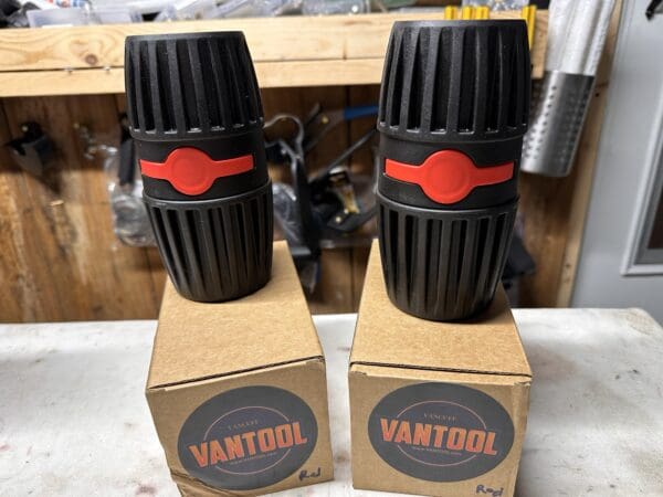 Two black Vantool red microphone covers.