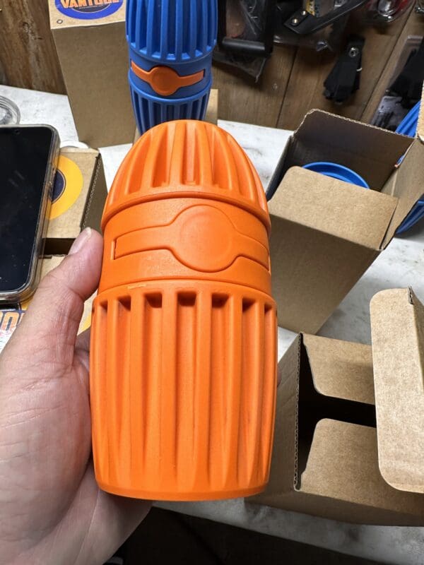 Orange ribbed massage roller in hand.